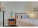 Well-lit bedroom features modern furniture, warm paint and decor on the walls at 8856 Timber Mesa St, Las Vegas, NV 89139