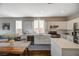 Modern kitchen features stainless steel appliances and white cabinets, flowing into the open living space at 8856 Timber Mesa St, Las Vegas, NV 89139