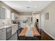 Bright kitchen features stainless steel appliances, white cabinetry, and stylish wood dining table at 8856 Timber Mesa St, Las Vegas, NV 89139