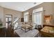 Bright living room featuring hardwood floors, large windows with sheer curtains, and neutral decor at 8856 Timber Mesa St, Las Vegas, NV 89139