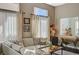 Bright living room with hardwood floors, sheer curtains, and a view into an adjacent room at 8856 Timber Mesa St, Las Vegas, NV 89139