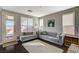 Cozy living room features neutral decor, a comfortable sectional couch, and bright natural light at 8856 Timber Mesa St, Las Vegas, NV 89139