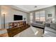 Comfortable living room with modern decor, a large TV, and outdoor access to the backyard at 8856 Timber Mesa St, Las Vegas, NV 89139