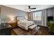 Inviting main bedroom with a ceiling fan, bench, and a large window at 8856 Timber Mesa St, Las Vegas, NV 89139