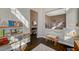 Open playroom view showcasing bookshelf-lined wall, access to living room, and modern neutral decor at 8856 Timber Mesa St, Las Vegas, NV 89139