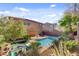 Spacious backyard featuring a refreshing pool, mature trees, and a cozy covered patio perfect for entertaining at 9413 Ironsend St, Las Vegas, NV 89143