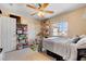 Well-lit bedroom with a large window, shelving, closet and a neutral color scheme at 9413 Ironsend St, Las Vegas, NV 89143