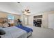 Large bedroom with fan, a seating area, and a door to the outdoor balcony at 9413 Ironsend St, Las Vegas, NV 89143