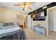 Bedroom with a wall mounted TV, and a shelf with toys and decor at 9413 Ironsend St, Las Vegas, NV 89143