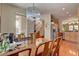 The dining room has a wood table with seating for six under a chandelier at 9413 Ironsend St, Las Vegas, NV 89143