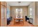 Spacious dining area with wood floors, large windows, and elegant chandelier, perfect for Gathering meals at 9413 Ironsend St, Las Vegas, NV 89143