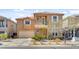 Charming two-story home with a yellow front door and a balcony over the entry at 9413 Ironsend St, Las Vegas, NV 89143