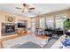 Comfortable living room with a fireplace, TV, and access to the backyard pool area at 9413 Ironsend St, Las Vegas, NV 89143