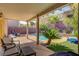 Covered patio that overlooks a backyard with pool and professional landscaping at 9413 Ironsend St, Las Vegas, NV 89143