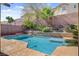 Stunning swimming pool surrounded by elegant brickwork and lush tropical landscaping for a private oasis at 9413 Ironsend St, Las Vegas, NV 89143