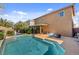 Inviting backyard pool area with lush landscaping and comfortable seating under a shaded patio at 9413 Ironsend St, Las Vegas, NV 89143