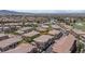 Aerial view of a community featuring well-maintained homes, lush landscaping, and serene lakes at 1040 Via Panfilo Ave, Henderson, NV 89011