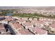 Aerial view of a community featuring well-maintained homes, green spaces and a pond at 1040 Via Panfilo Ave, Henderson, NV 89011