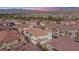 Aerial view of a residential area featuring well-maintained homes and a golf course in the distance at 1040 Via Panfilo Ave, Henderson, NV 89011