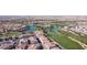 Scenic aerial view showcasing a residential area adjacent to a well-maintained golf course with picturesque water features at 1040 Via Panfilo Ave, Henderson, NV 89011