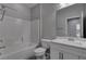 Clean bathroom featuring a shower-tub combo, white vanity, and tile flooring, offering a fresh and functional space at 1040 Via Panfilo Ave, Henderson, NV 89011
