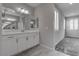 Contemporary bathroom with dual sinks, modern lighting, and plantation shutters at 1040 Via Panfilo Ave, Henderson, NV 89011