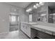 Bathroom with dual sinks, quartz countertops, and neutral color palette at 1040 Via Panfilo Ave, Henderson, NV 89011