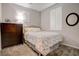 Cozy bedroom featuring neutral tones, two windows, and a matching dresser at 1040 Via Panfilo Ave, Henderson, NV 89011