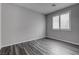 Neutral bedroom with wood plank flooring, one window and recessed lighting at 1040 Via Panfilo Ave, Henderson, NV 89011