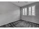 Bedroom with neutral paint, carpet flooring, and windows with shutters, creating a cozy and well-lit retreat at 1040 Via Panfilo Ave, Henderson, NV 89011