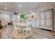 Spacious open concept dining area with hardwood floors, white table and seating for four at 1040 Via Panfilo Ave, Henderson, NV 89011