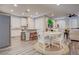 Open concept dining area featuring a round table, hardwood floors and plenty of natural light at 1040 Via Panfilo Ave, Henderson, NV 89011