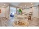 Open concept dining area featuring a round table, hardwood floors and flows into the kitchen and office at 1040 Via Panfilo Ave, Henderson, NV 89011