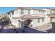 Inviting exterior of a two-story townhome, featuring a cozy front patio and desert landscaping at 1040 Via Panfilo Ave, Henderson, NV 89011