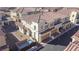 Aerial view showcasing a two-story townhome with a two car garage and desert landscaping at 1040 Via Panfilo Ave, Henderson, NV 89011