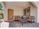 Inviting front patio featuring comfortable seating, a table, and stylish pavers, perfect for relaxation at 1040 Via Panfilo Ave, Henderson, NV 89011