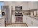 Bright kitchen featuring stainless steel appliances, granite countertops, and ample storage with stylish white cabinets at 1040 Via Panfilo Ave, Henderson, NV 89011