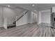 Inviting living room showcases staircase, stylish gray wood floors, and neutral paint at 1040 Via Panfilo Ave, Henderson, NV 89011
