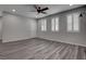 Spacious living room features modern plantation shutters, gray wood floors, and contemporary lighting at 1040 Via Panfilo Ave, Henderson, NV 89011