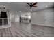 Open-concept living area showcasing seamless flow to the kitchen with sleek gray wood floors at 1040 Via Panfilo Ave, Henderson, NV 89011