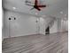 Bright living room boasts stylish gray wood floors and a modern ceiling fan for ultimate comfort at 1040 Via Panfilo Ave, Henderson, NV 89011