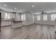 Spacious living room featuring plank floors, recessed lighting, ceiling fan, and abundant natural light from shuttered windows at 1040 Via Panfilo Ave, Henderson, NV 89011