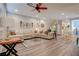 Bright and airy living room featuring a large comfortable sofa, modern decor, and wood-look flooring at 1040 Via Panfilo Ave, Henderson, NV 89011