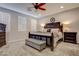 Cozy main bedroom features a ceiling fan, plantation shutters and dark wood furniture at 1040 Via Panfilo Ave, Henderson, NV 89011