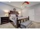 Cozy main bedroom features a ceiling fan, plantation shutters and dark wood furniture at 1040 Via Panfilo Ave, Henderson, NV 89011