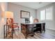 Well-lit office space with dark wood desk, hardwood floors and plantation shutters for privacy at 1040 Via Panfilo Ave, Henderson, NV 89011