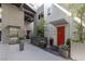 Condo entrance featuring modern architecture, red doors, elevator, and grey planter-lined walkways at 11441 Allerton Park Dr # 217, Las Vegas, NV 89135