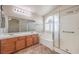 Well-lit bathroom boasts double vanity, soaking tub, and glass shower at 1332 Cedar Berry Ct, Henderson, NV 89012