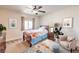 Cozy staged bedroom with natural light, fan, stylish furnishings, and light decor at 1332 Cedar Berry Ct, Henderson, NV 89012