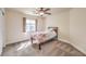 Bright bedroom with a ceiling fan, a window, and neutral toned walls at 1332 Cedar Berry Ct, Henderson, NV 89012